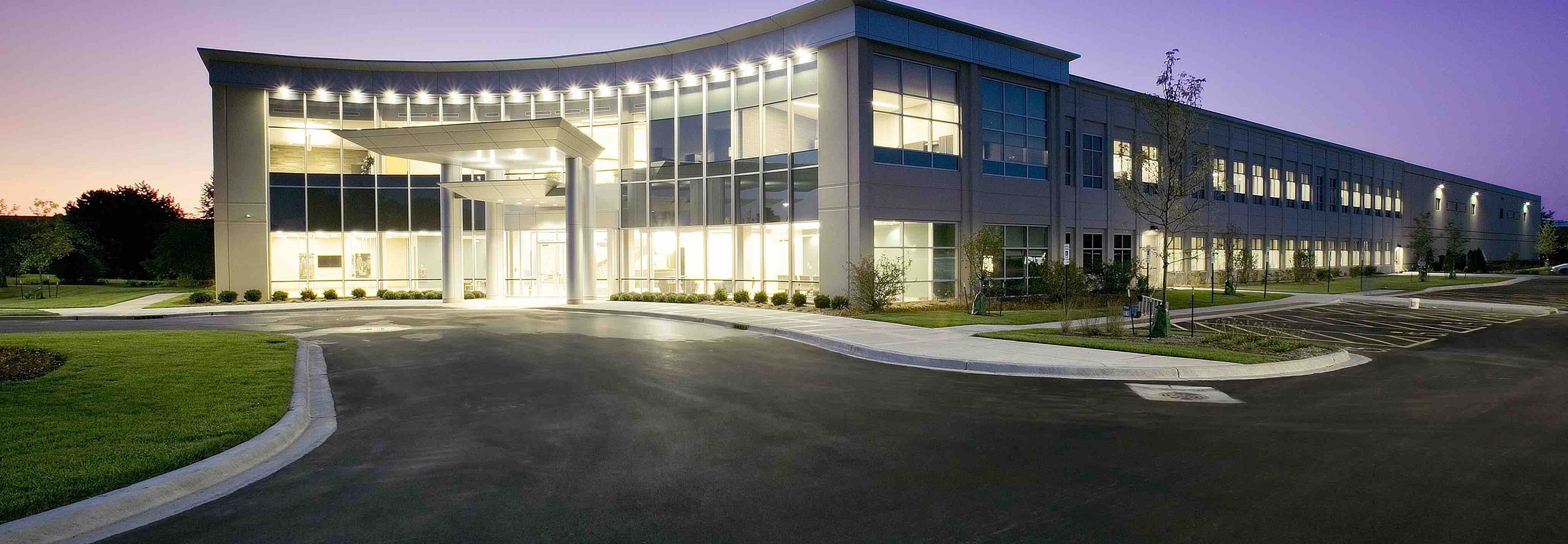The exterior view of Echo Corporate Center illuminated at night.