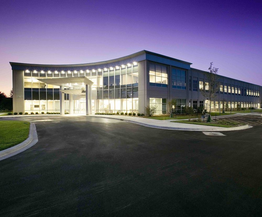 The exterior view of Echo Corporate Center illuminated at night.