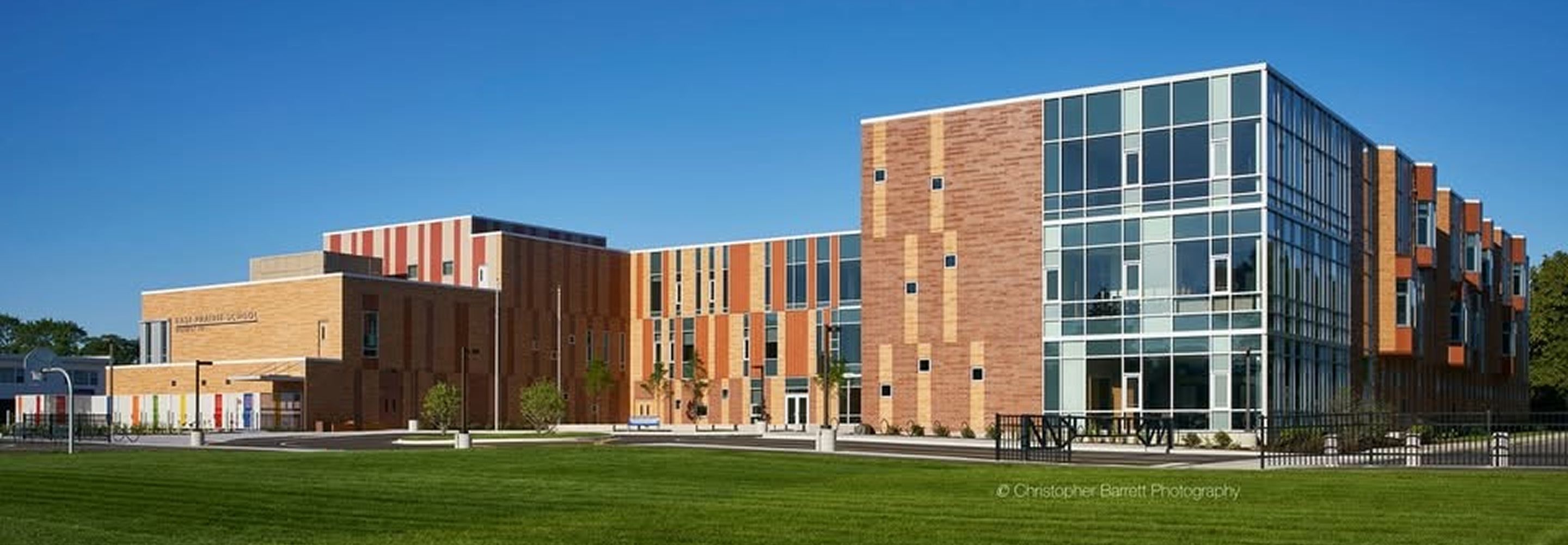 The exterior of East Prairie School surrounded by a large grass field.