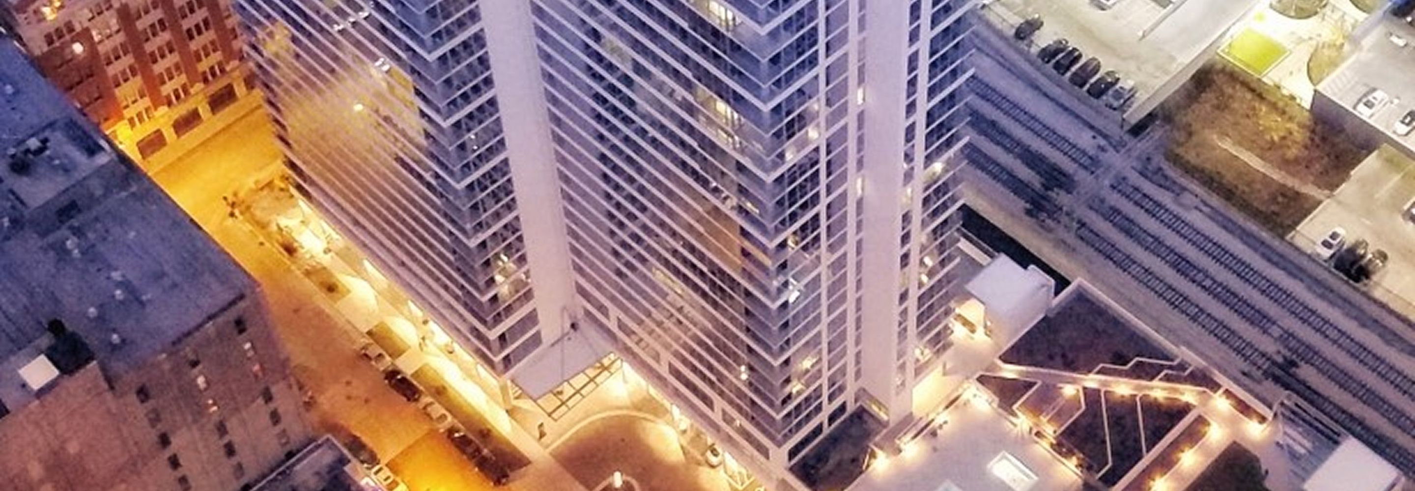 The exterior of Alta Roosevelt with bright lights at night.