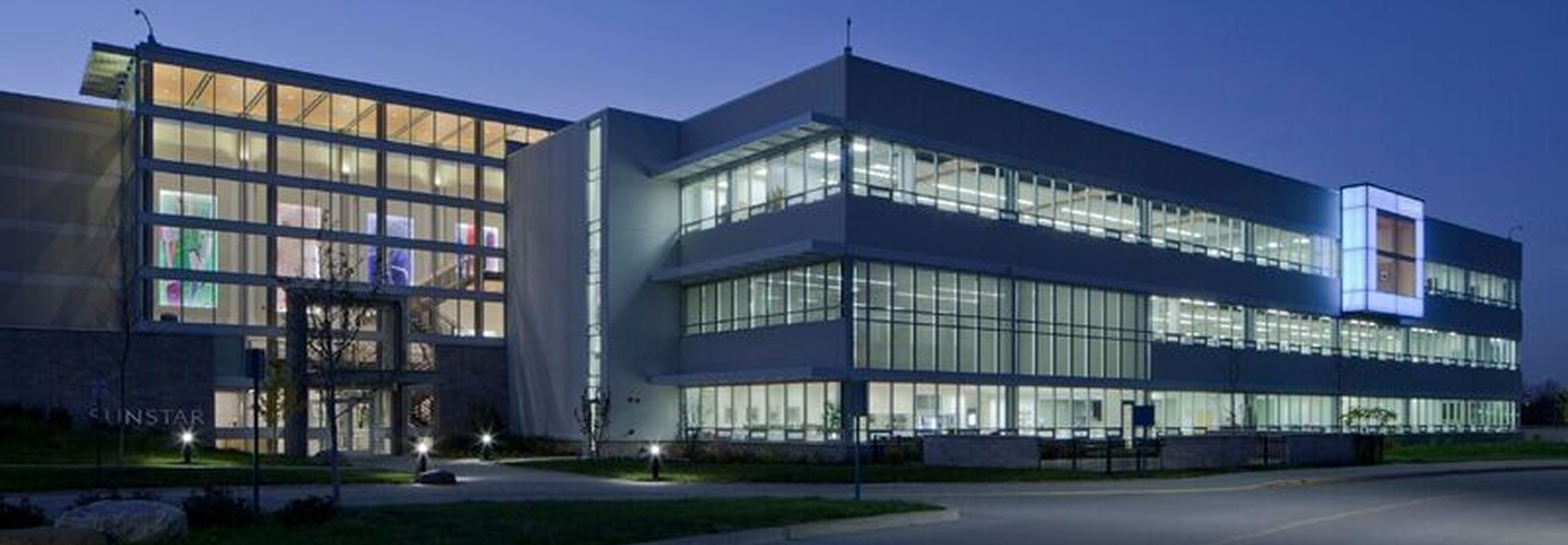 The illuminated exterior facade of Sunstar at nighttime.