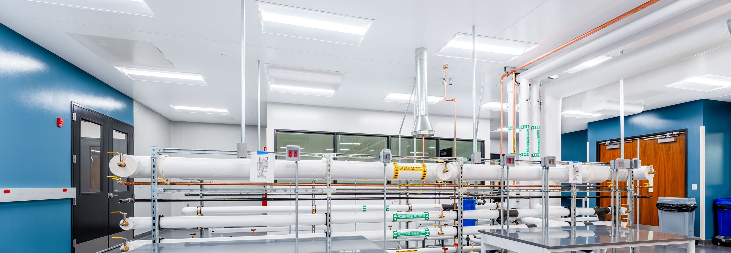Laboratory with tables, equipment and many bright ceiling lights.