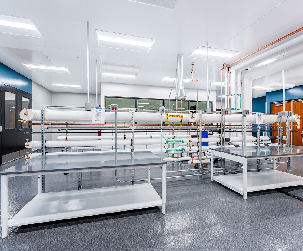 Laboratory with tables, equipment and many bright ceiling lights.