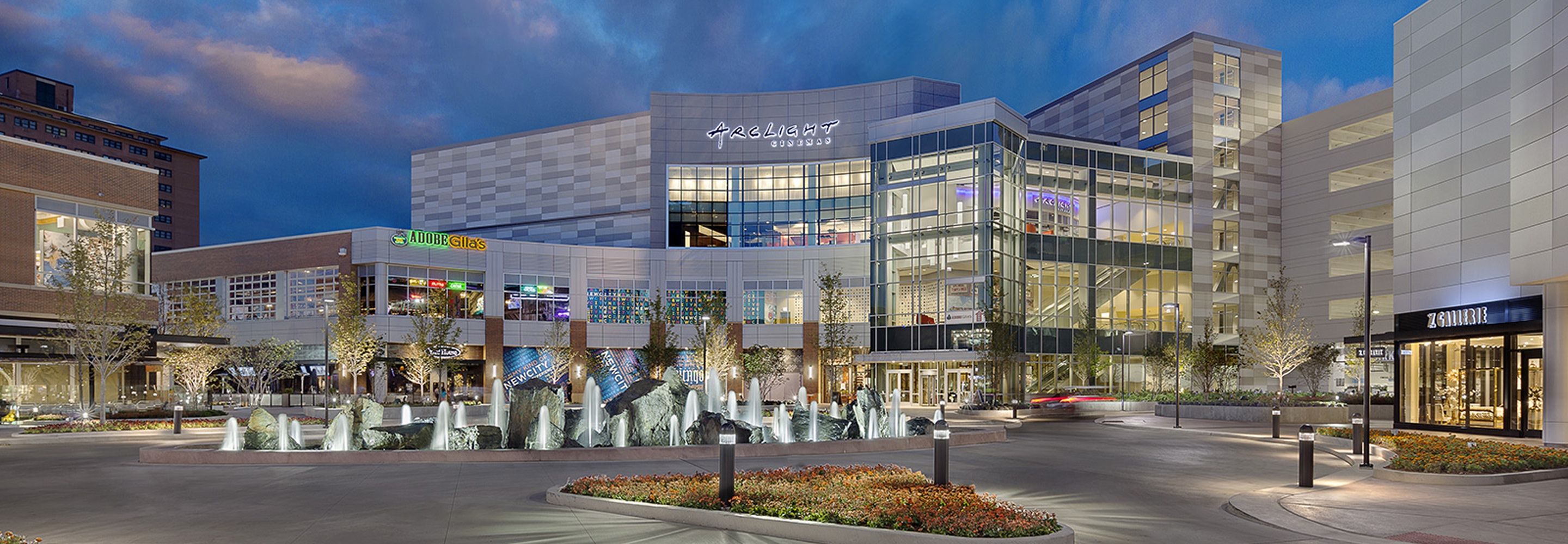 The outside of New City, illuminated by store and pole lights later during the day.