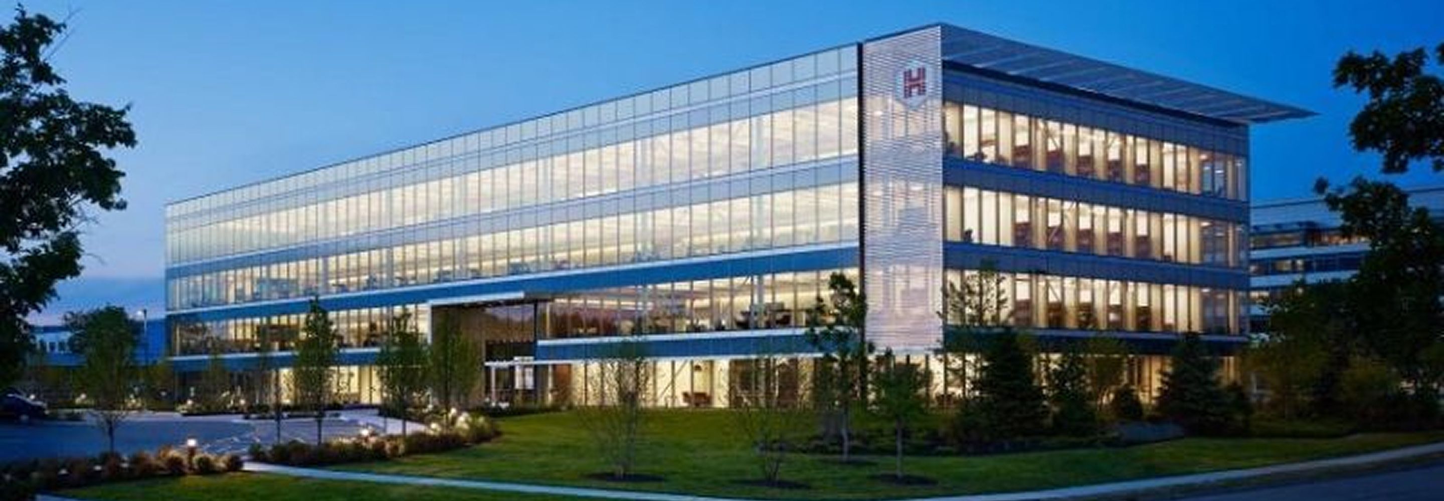 An outside view of the HUB Group HQ exterior illuminated at night.