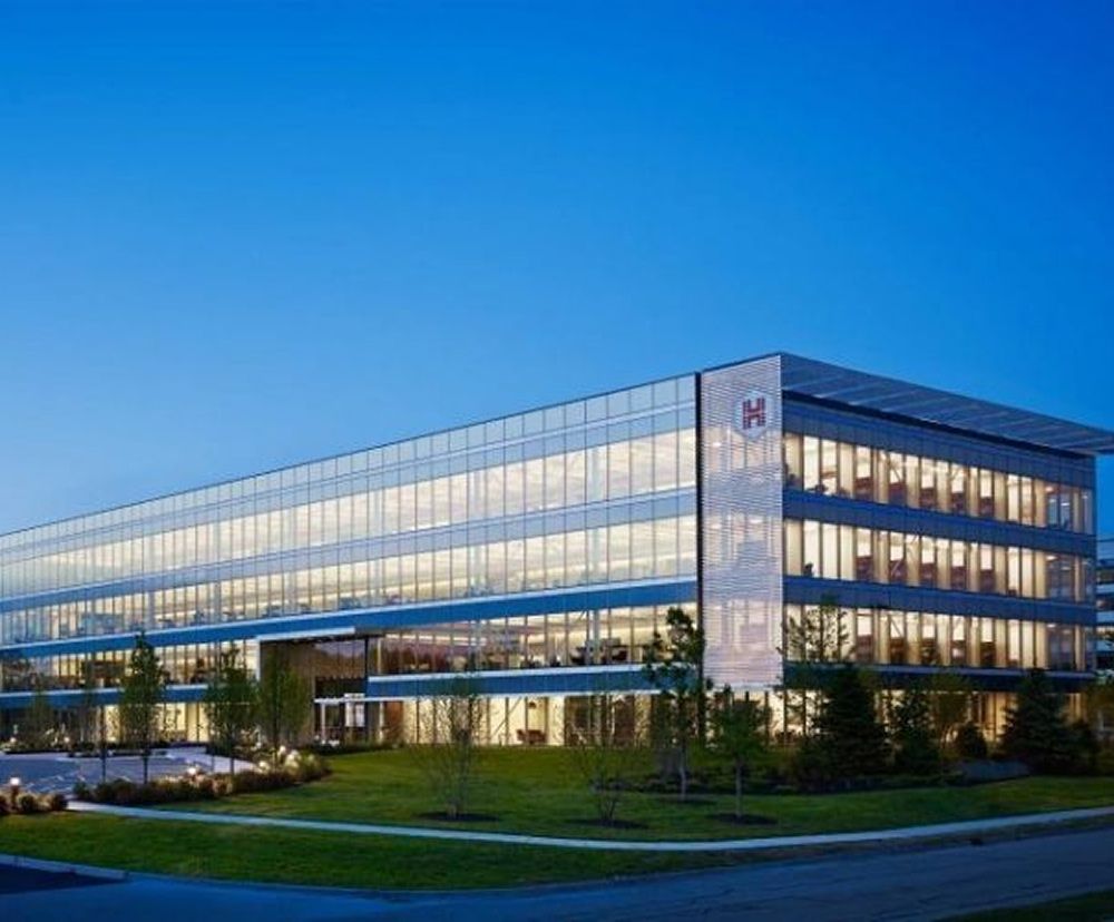 An outside view of the HUB Group HQ exterior illuminated at night.