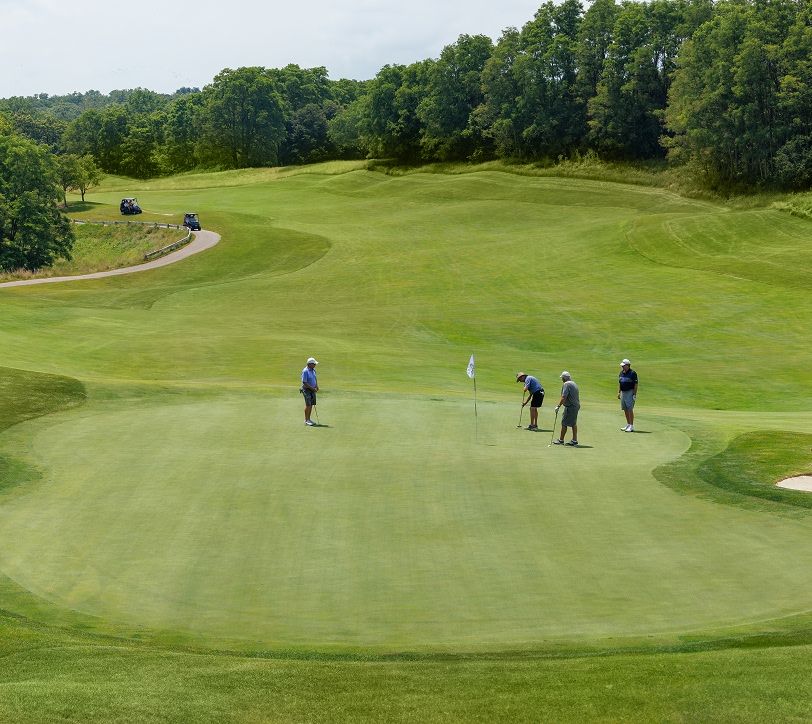 group of four golfers putting at GNC's Golf Course