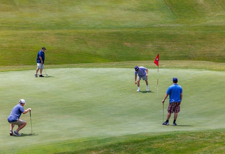 group of four golfers putting at GNC's Golf Course