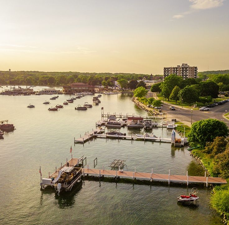 An aerial view of the lake, boats, and surrounding area of downtown Lake Geneva