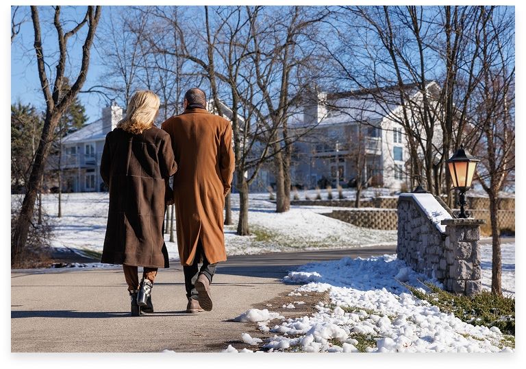 couple walking along a path in the winter