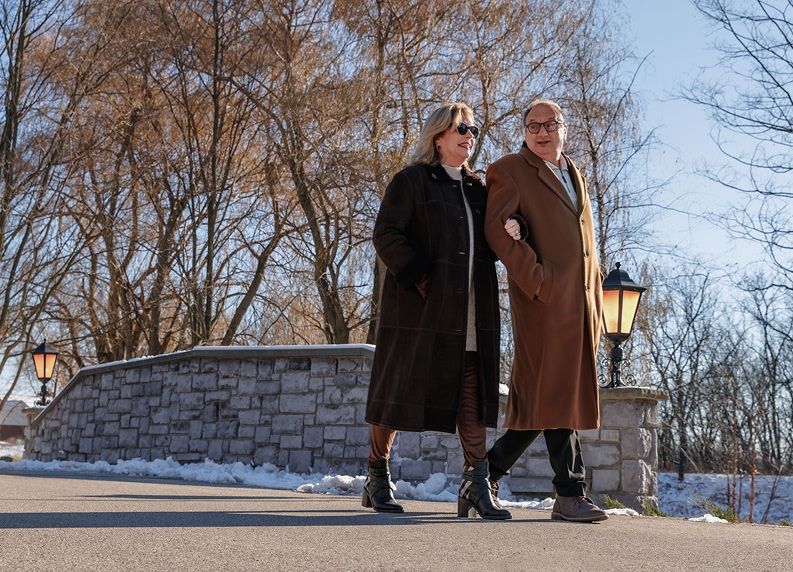 couple walking along a path in the winter