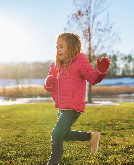 child running through park in Geneva National Community