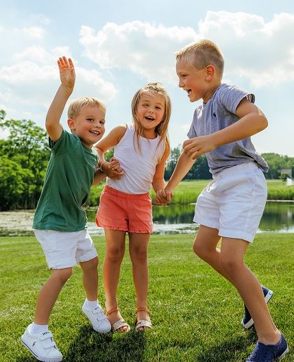 three kids playing outside together at GNC