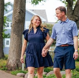Couple walking along a path in Geneva National Community holding hands