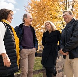 two couples stop to chat on a walk