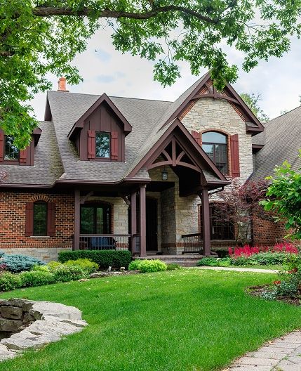 Traditional cobblestone home with green lawn