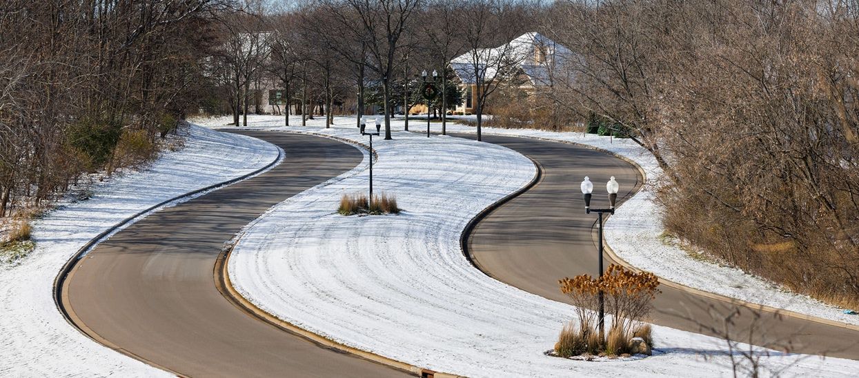 winding road entrance with snow during winter