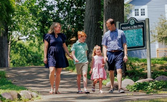 family walking along a path at Geneva National Community