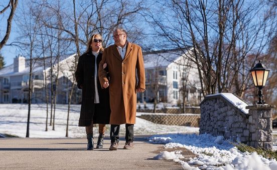 couple walking along a path in the winter
