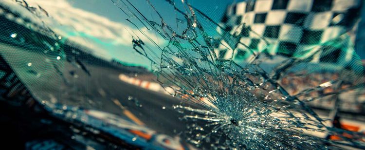 A closeup on a spiderweb windshield crack