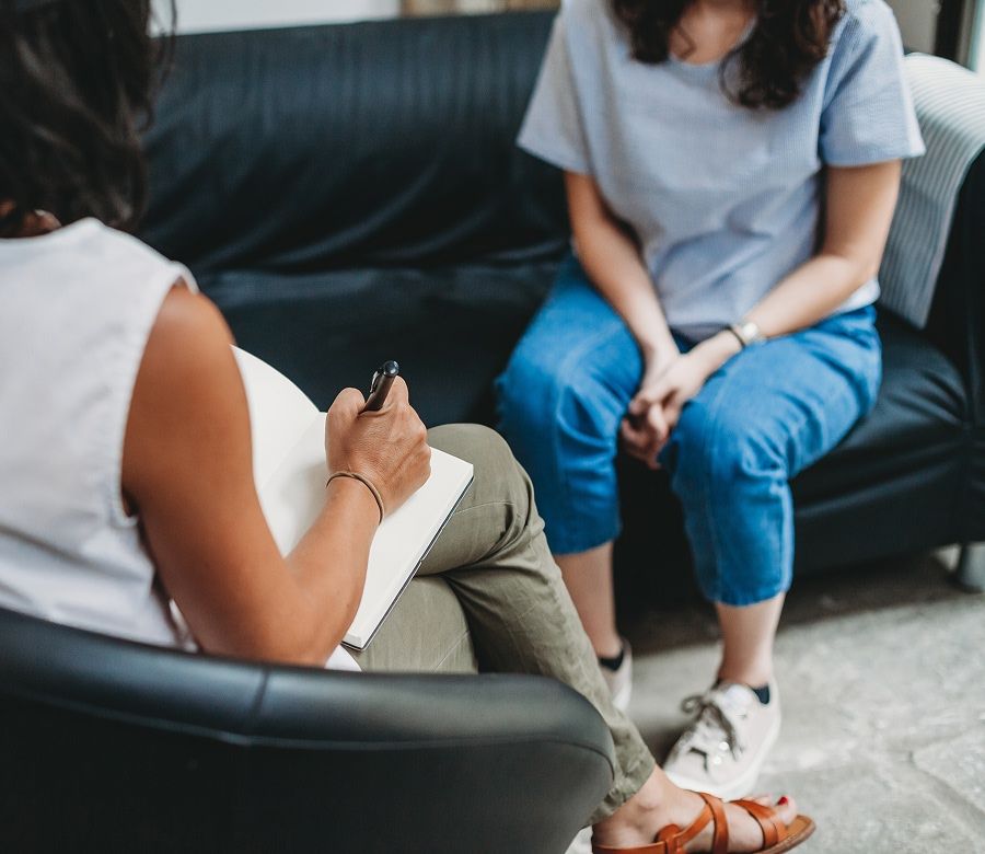 woman meeting with a therapist in her office