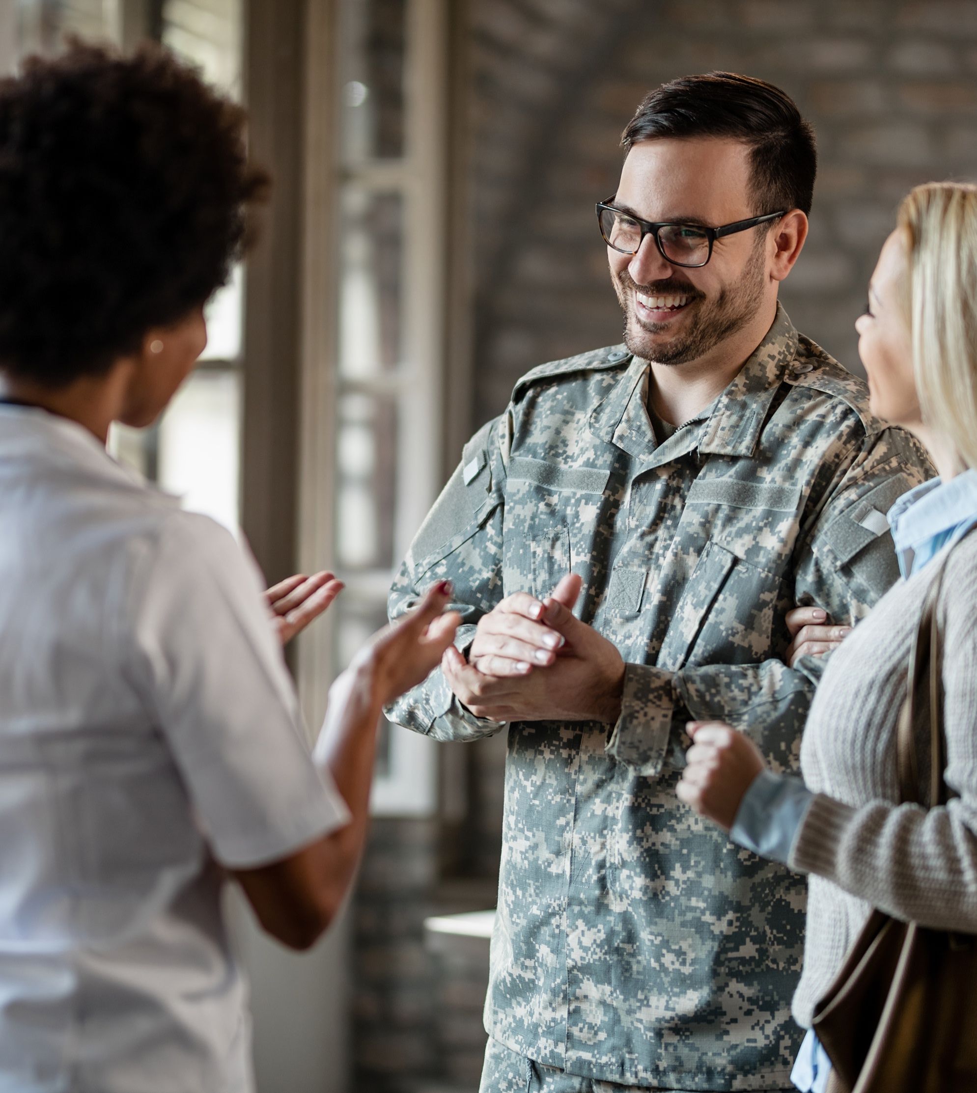 veteran talking to community member with his wife