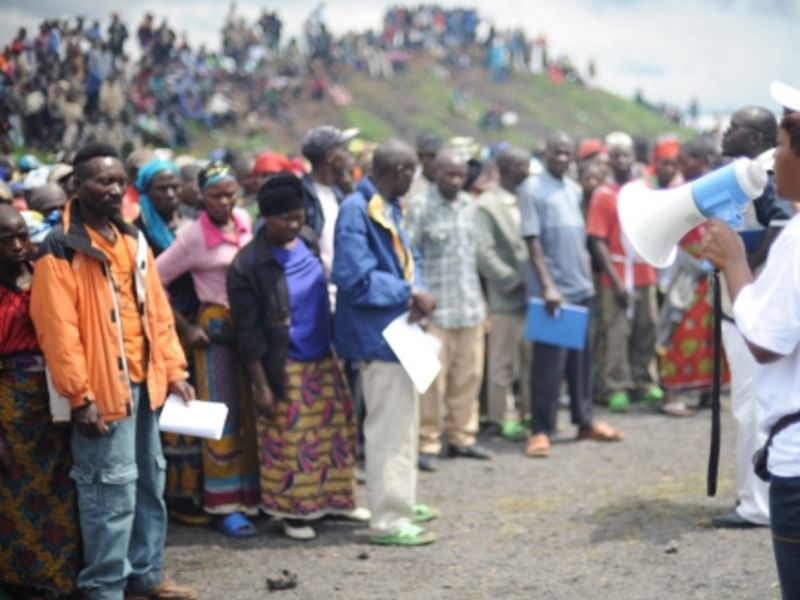 NGO workers prepare to distribute aid at a refugee camp in Rwanda (Photo: Julien Harneis)