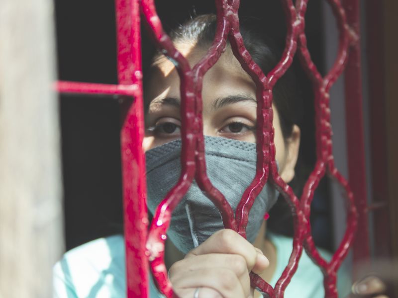 Indian girl protecting herself and wearing a mask against the coronavirus during lockdown.