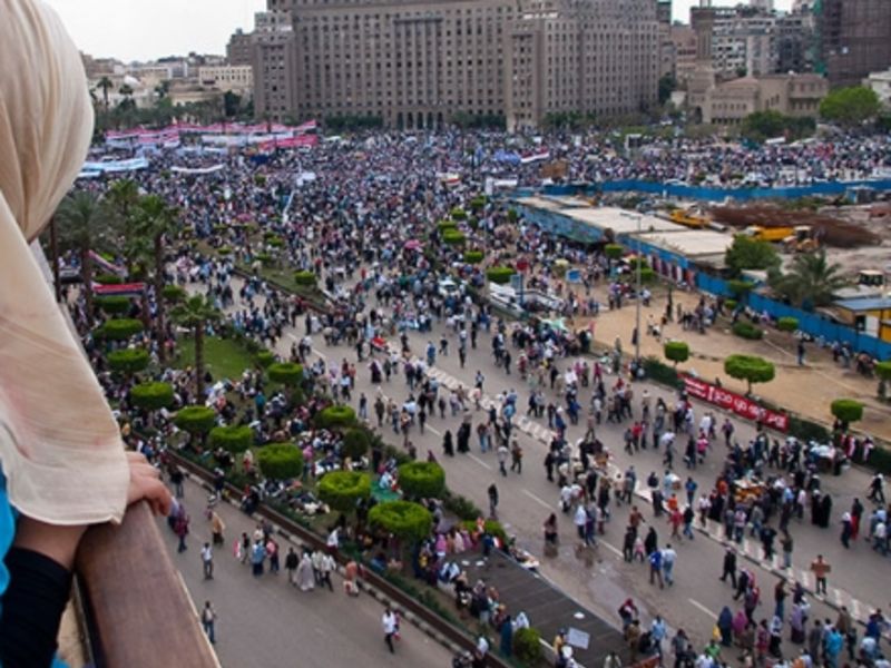 Tahrir Square, Egypt in 2011 (Photo: Flickr user James); A market in Mauritius (Photo: Samovar Incentive)