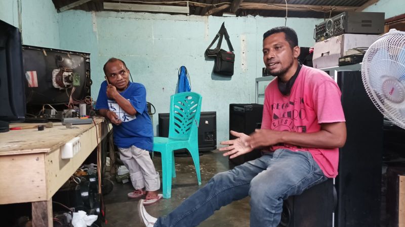 Adrian (left) and Jois (right) have set up an electronics repair shop