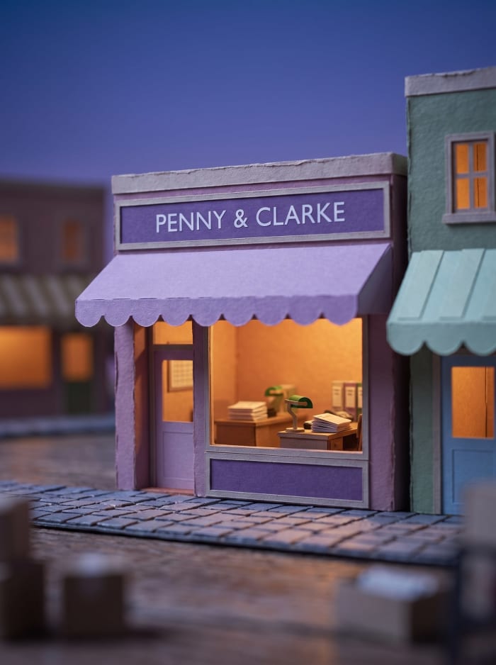 A model accountants office with a violet awning and lamplit desks.