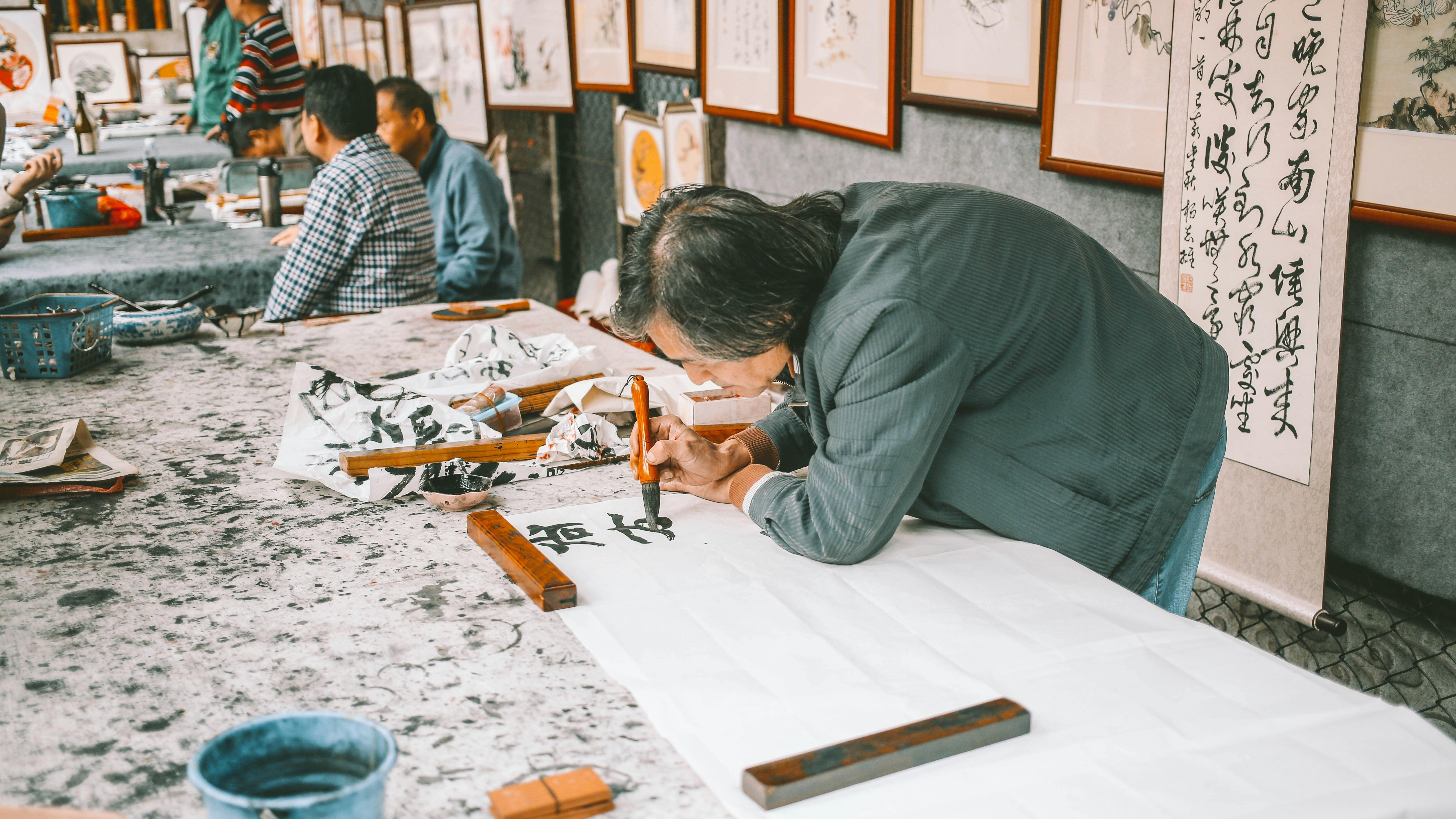 A person enjoying the mindful process of calligraphy in a calm and creative workspace.
