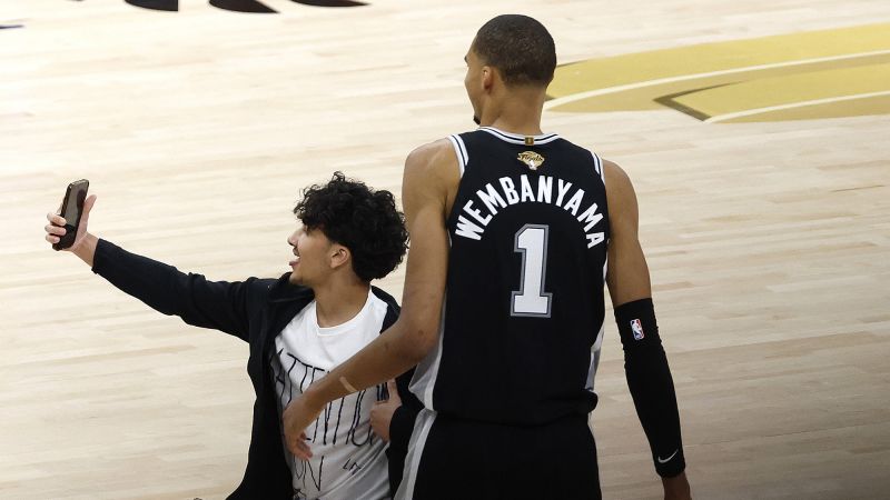 Fan arrested and permanently banned after running onto NBA Finals court to take selfie with Victor Wembanyama