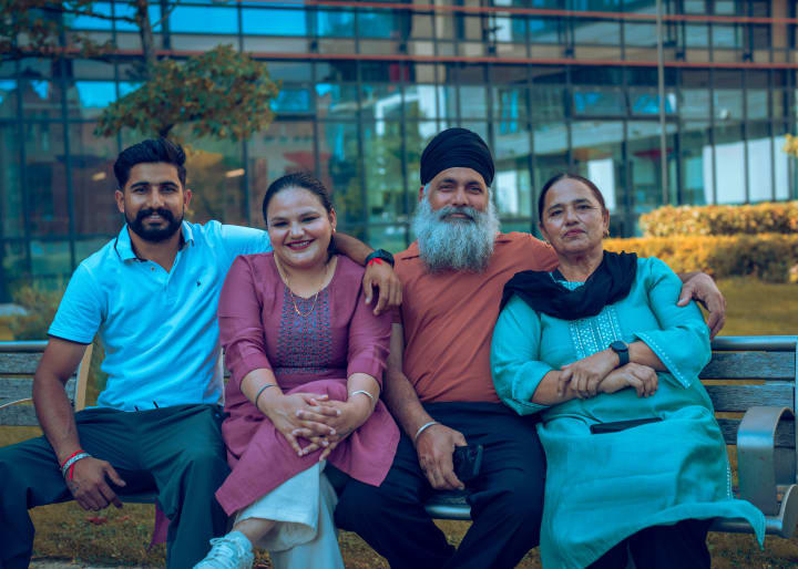 The family on the bench, the younger pair in the middle