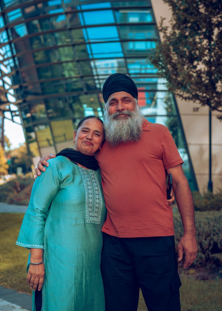 The couple standing together, smiling