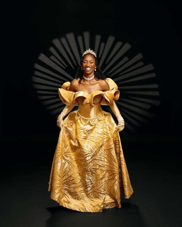 The gold gown and tiara against black, a white starburst behind her