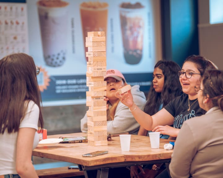 Jenga and bubble tea at a table