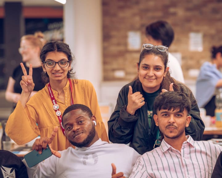 A group throwing peace signs for the camera