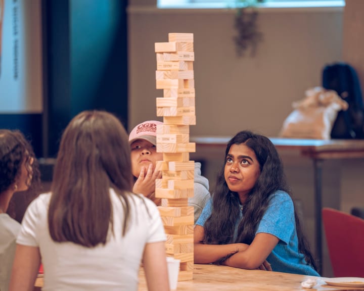 Three students at the Jenga table