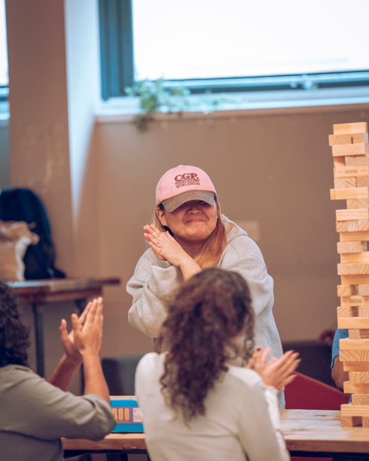 A student in a cap, mid-laugh