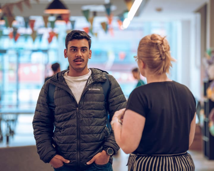 Two students laughing together