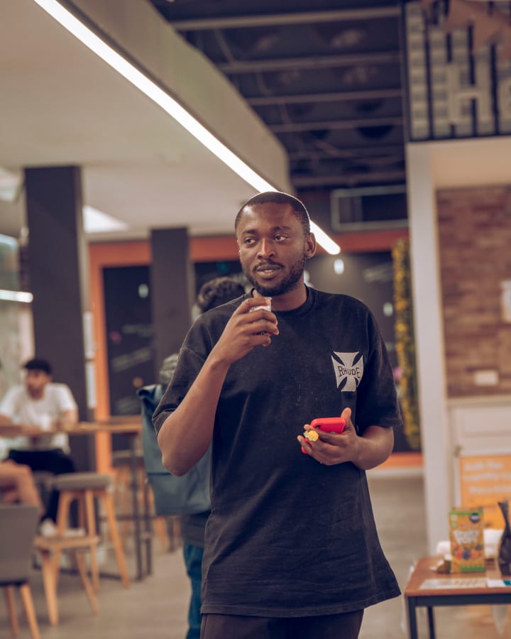 A student with a red cup, looking at the camera