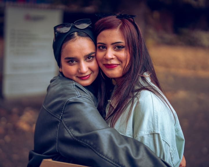 Two women embracing, one in leather