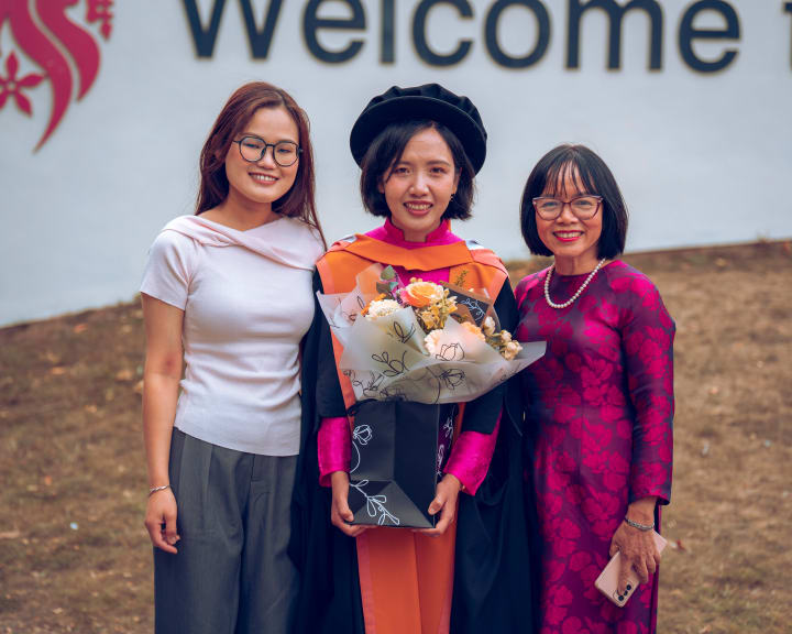 A family under the Welcome sign