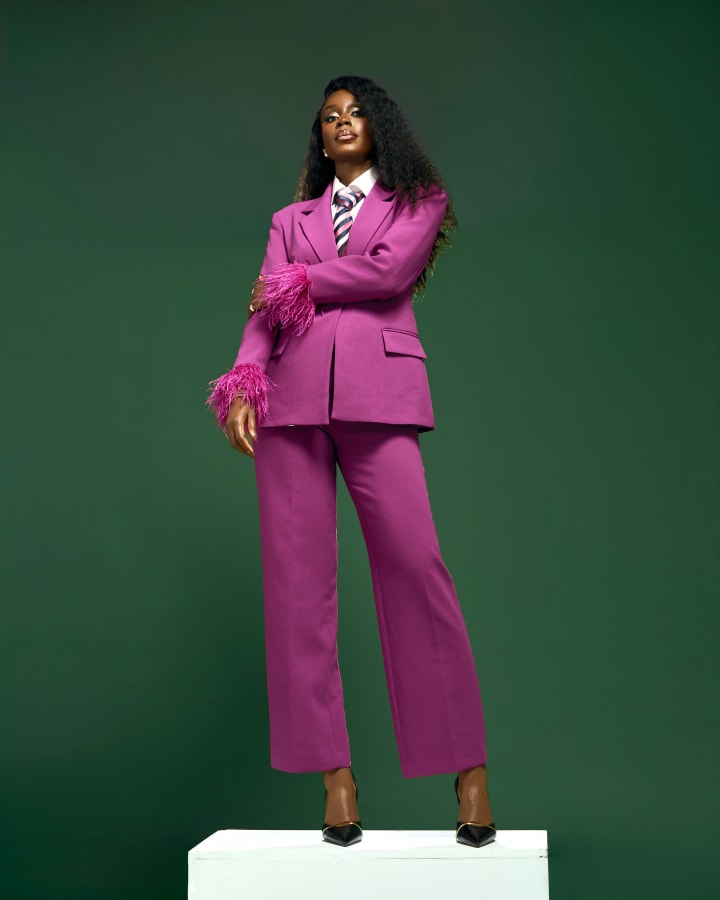 Standing on the plinth, full length, arms folded