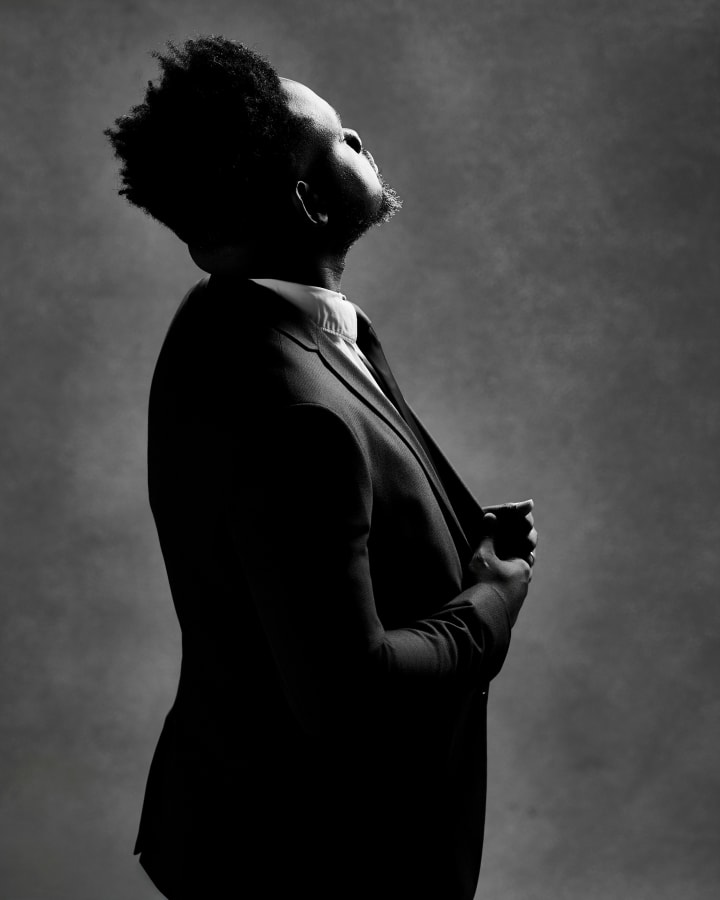 Head tipped right back, eyes closed, in black and white