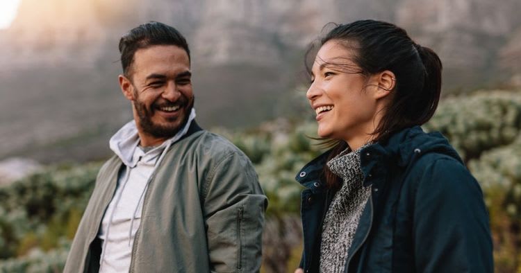 Two people engaged in conversation on a walk.