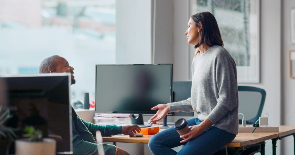 Two people having a chat at the workplace.