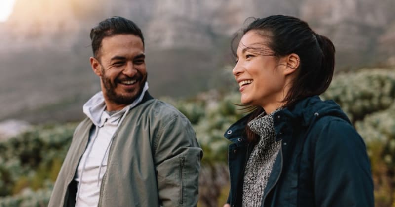 Two people engaged in conversation on a walk.