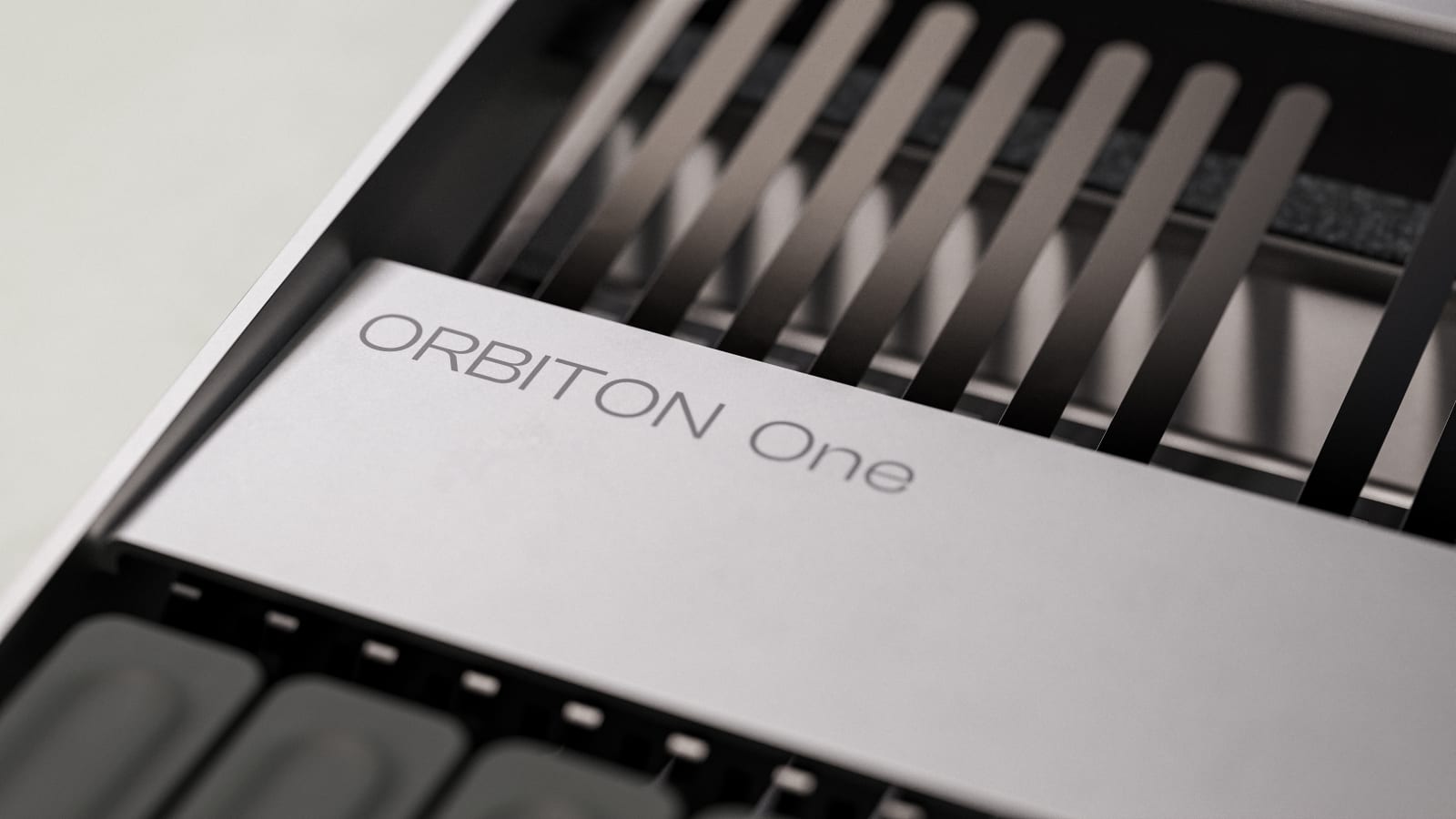 The lamella comb beside the Orbiton One mark